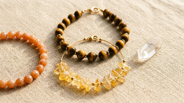 Photorealistic flat lay of crystal bracelets and a jewelry tray on linen in soft sunlight