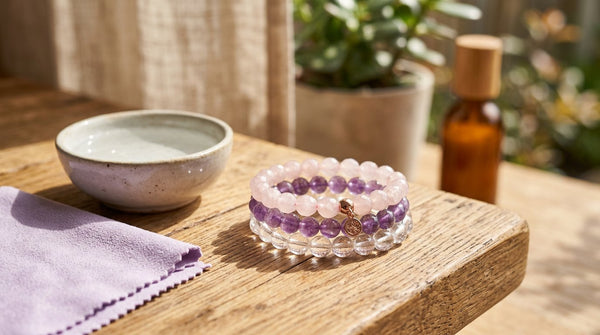 Crystal bead bracelets on a sunlit table with cleaning cloth (summer jewelry care).